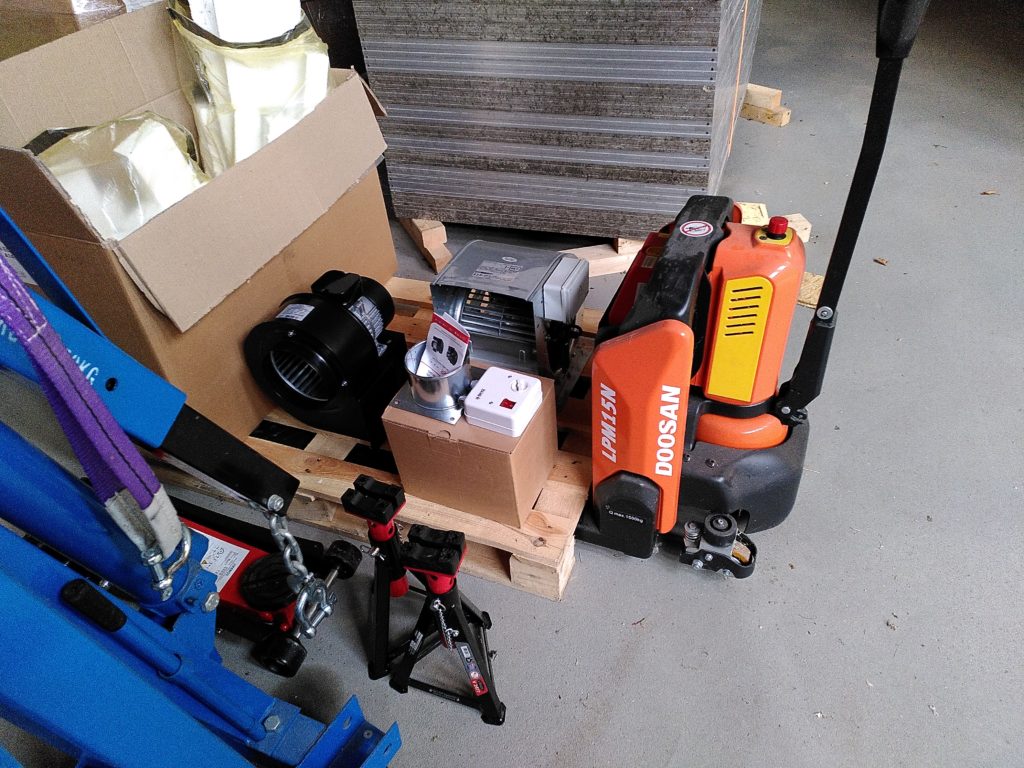 A wooden pallet with a turbo fan and a duct fan on it.