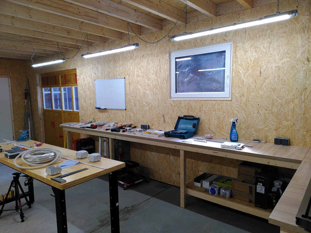 Shop interior, widow and whiteboard are visible over wooden workbenches.