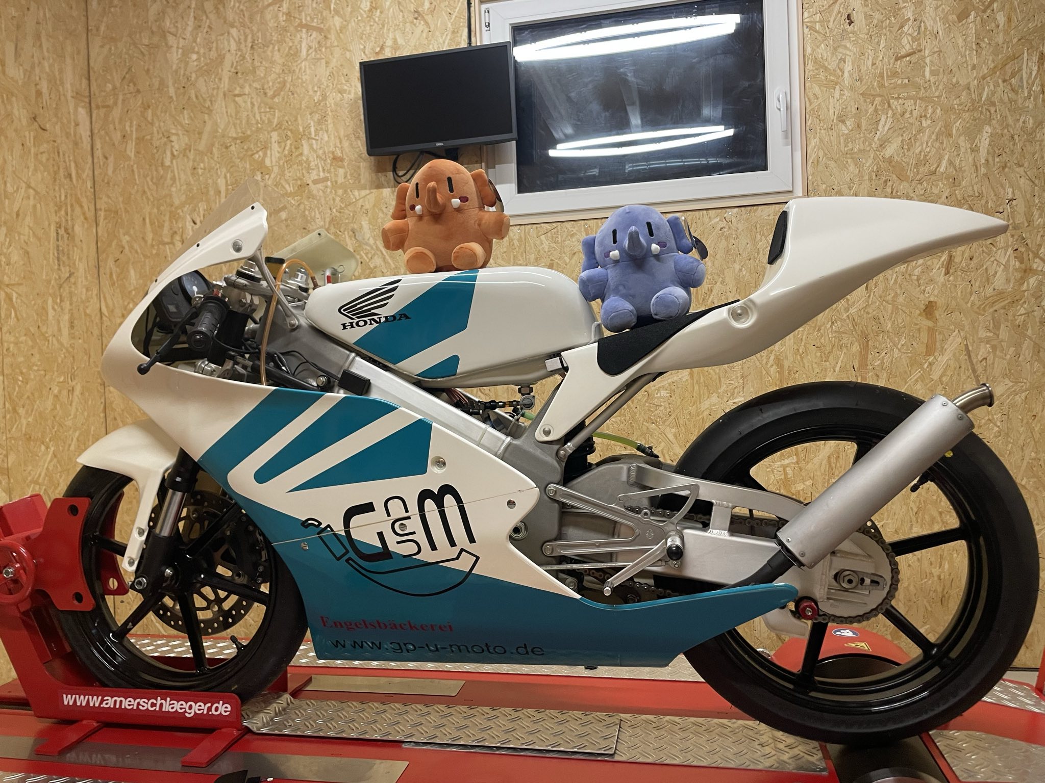 Plushtodons on a Honda RS125 Racing motorcycle sitting on a dyno.